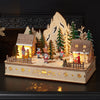 Light Up Santa’s Woodland Village Scene – 28cm